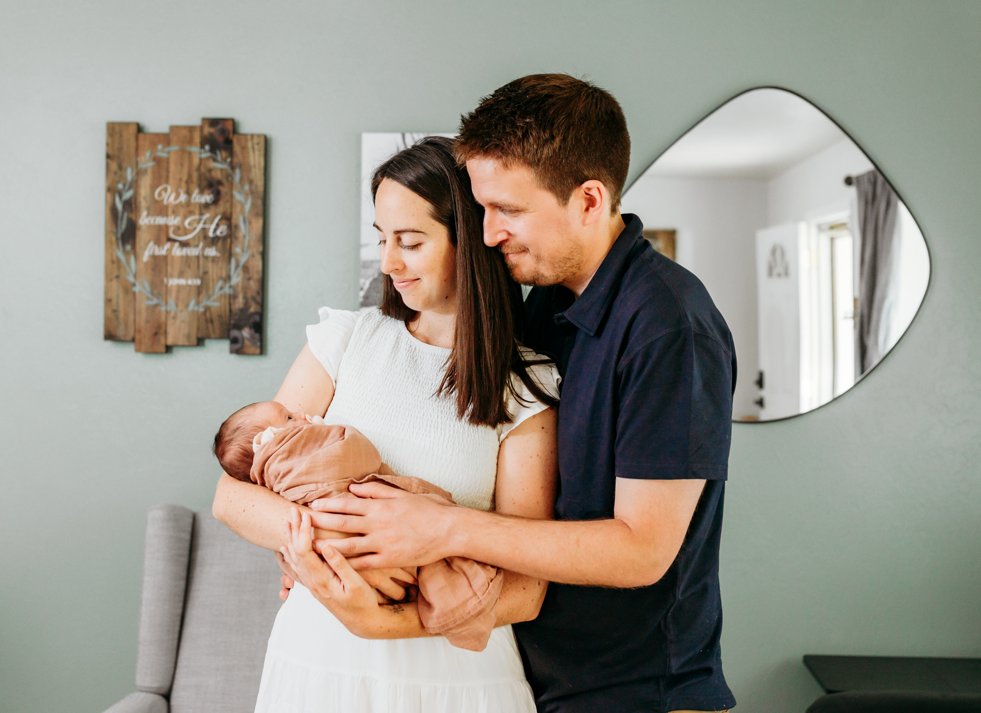 a mom and dad hold newborn during photo session