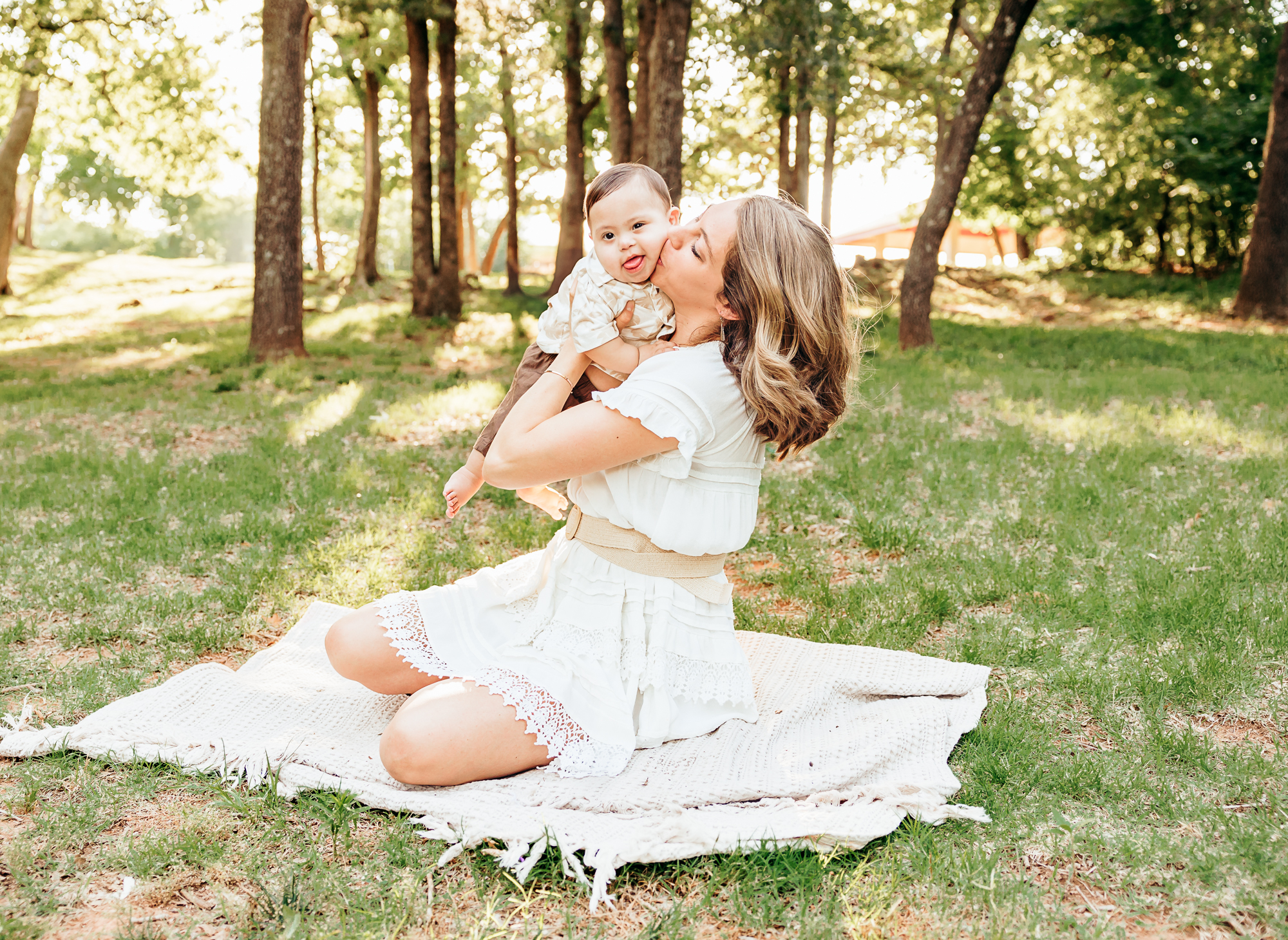 Mom snuggles baby during newborn session.