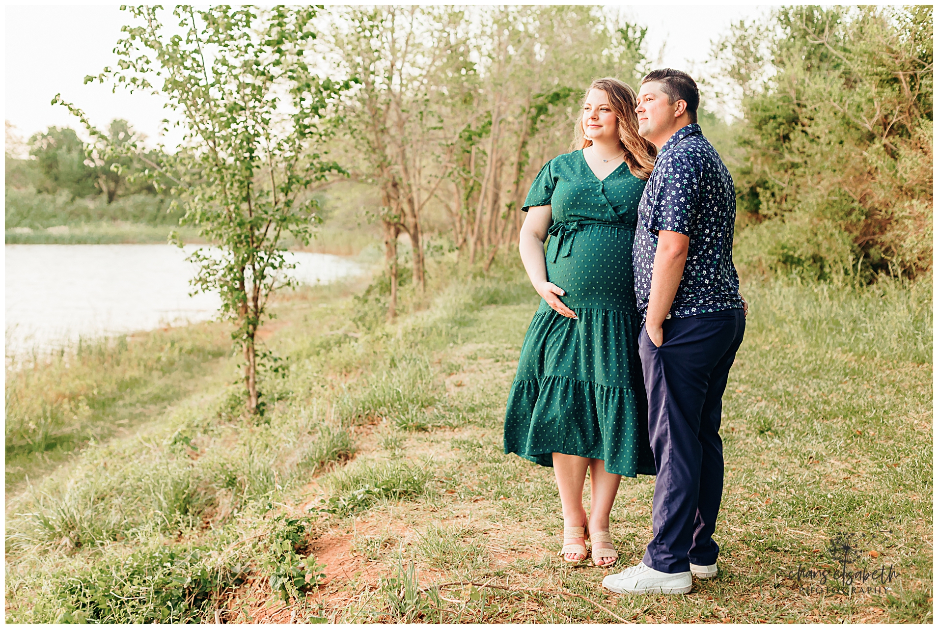 A couple stands by the pond at a park in OKC during maternity photos.