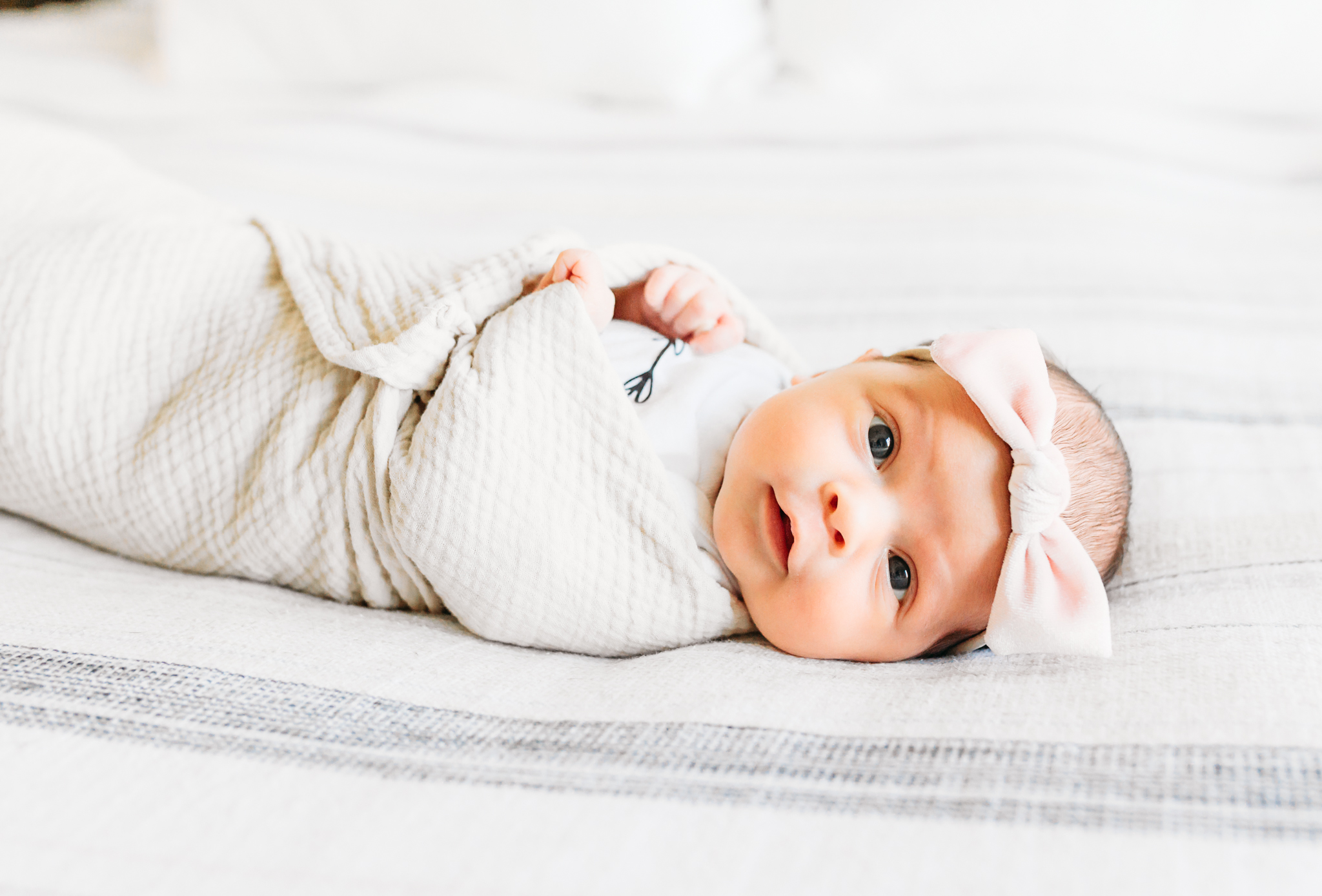 baby lays on bed during session