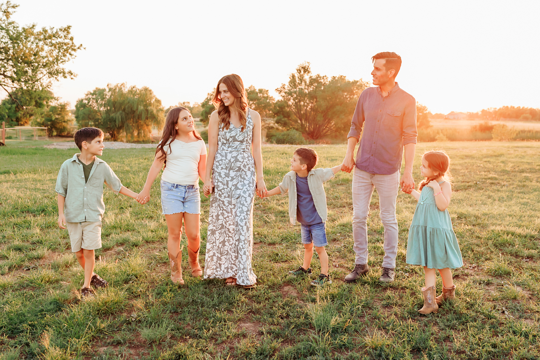 Family of 6 in golden sunlight during photo session.