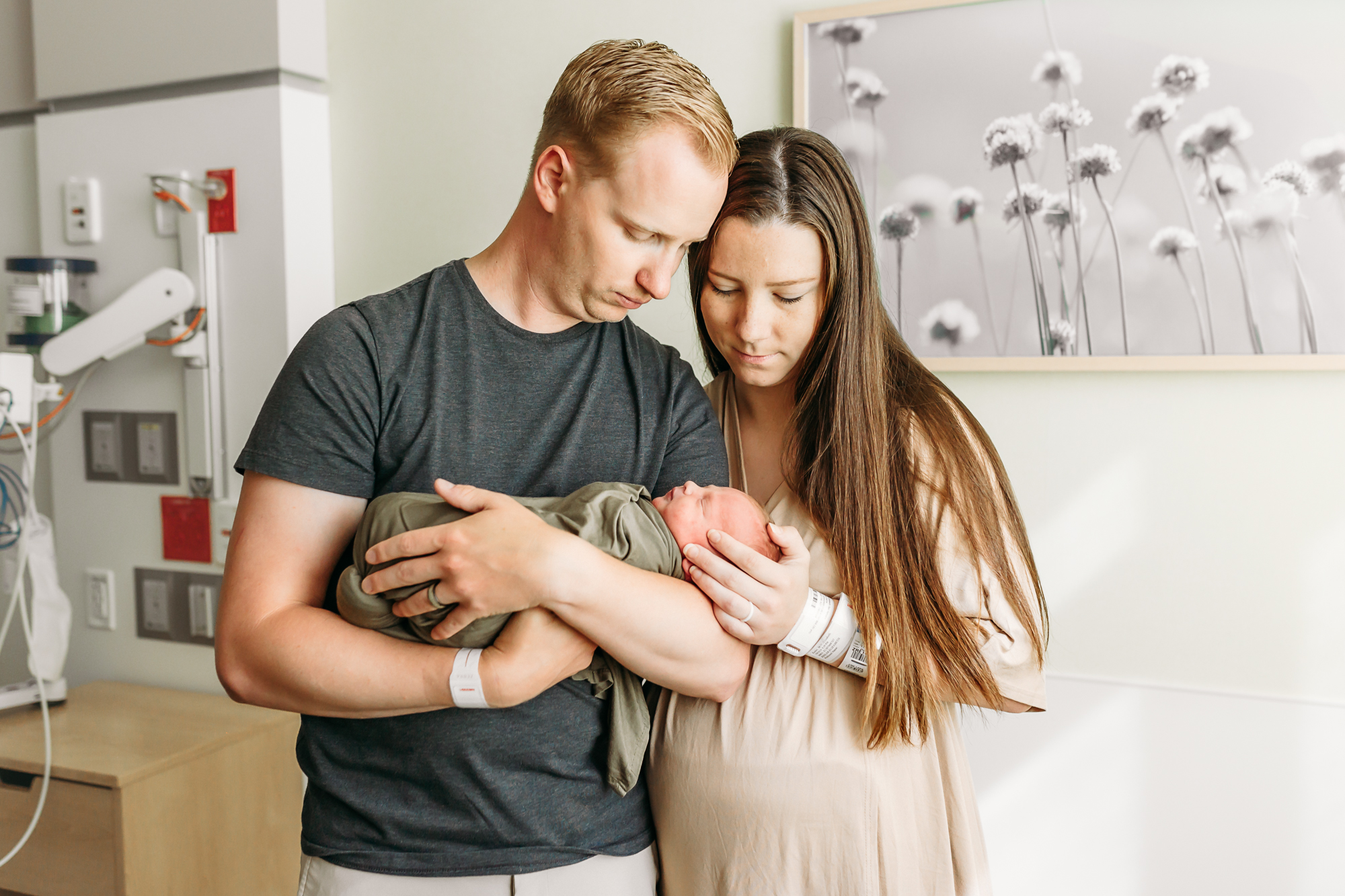 Dad holds his newborn daughter