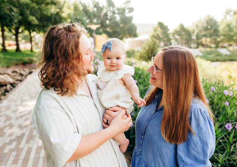 A mom and dad hold their little one during family photos at Myriad Gardens in downtown OKC.