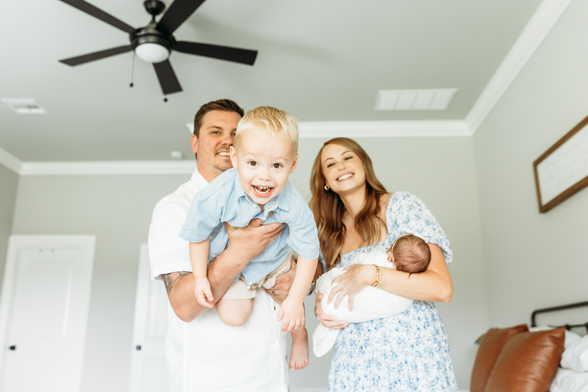 mom, dad, toddler and newborn during lifestyle photo session.