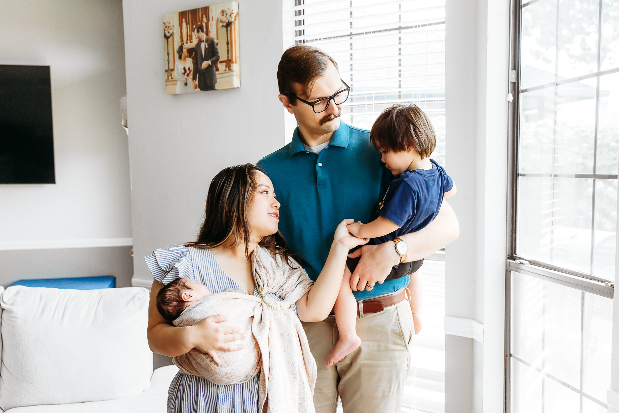 Mom wears baby during photos.