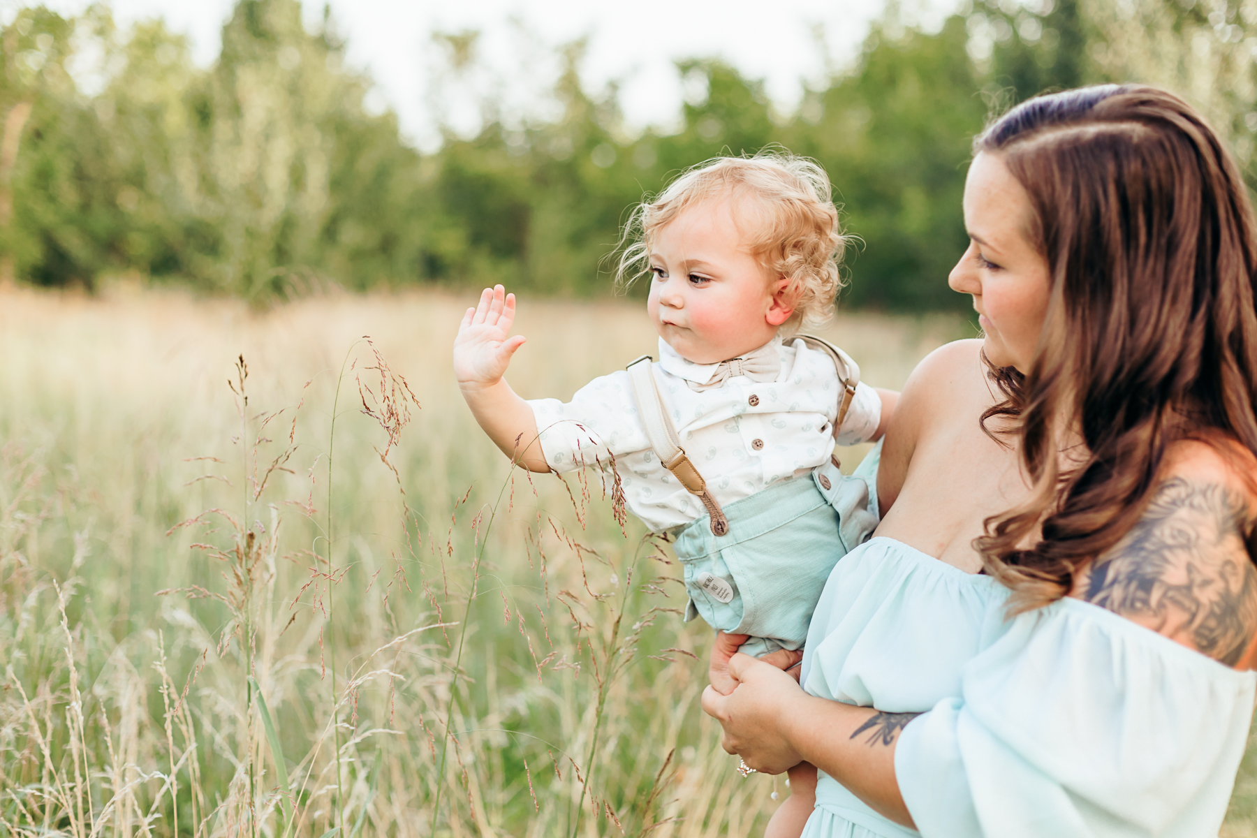 Newborn baby portrait in green sweater.