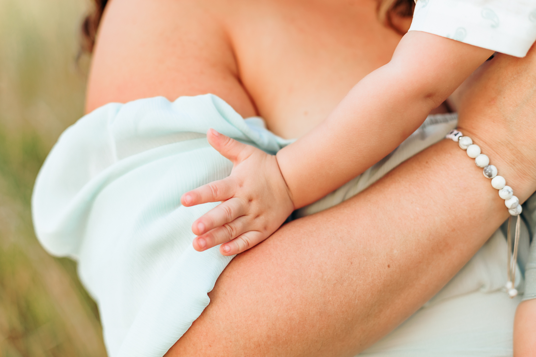 Mom wears baby during photos.