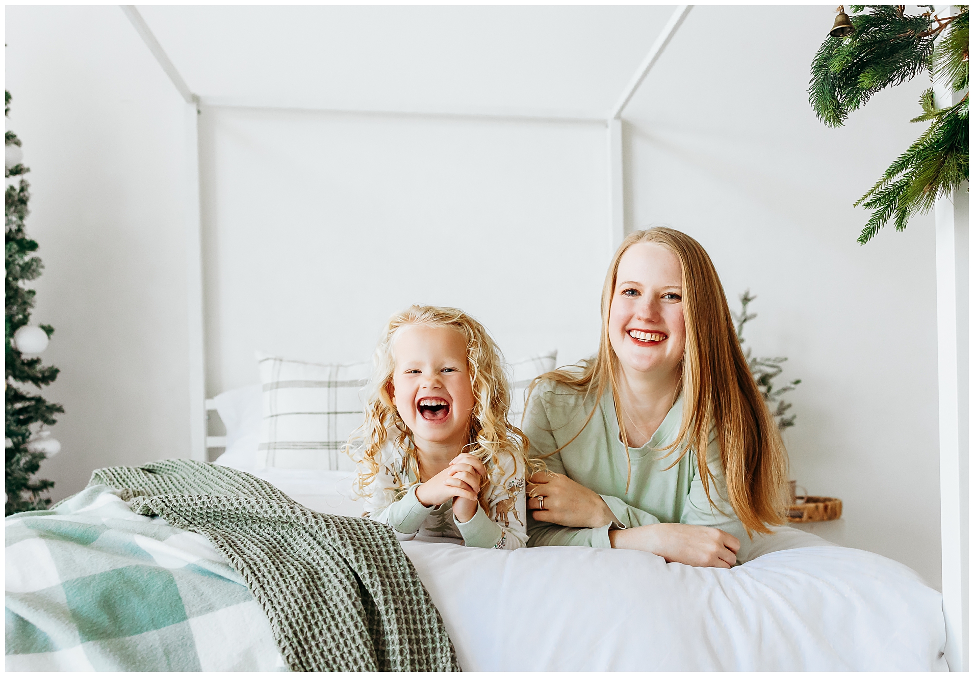 Mom and daughter laughting during Christmas mini photo session.